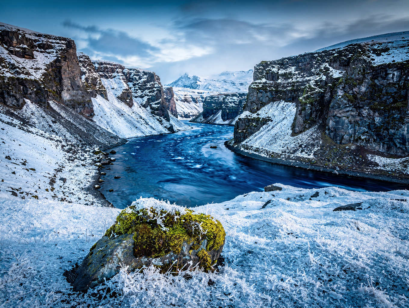 Basalt rock formations and glacial river in Icelandic canyon