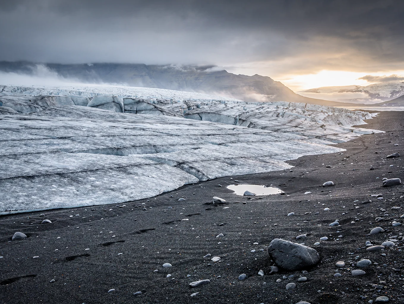 Glacial ice fragments on black basalt sand in Iceland